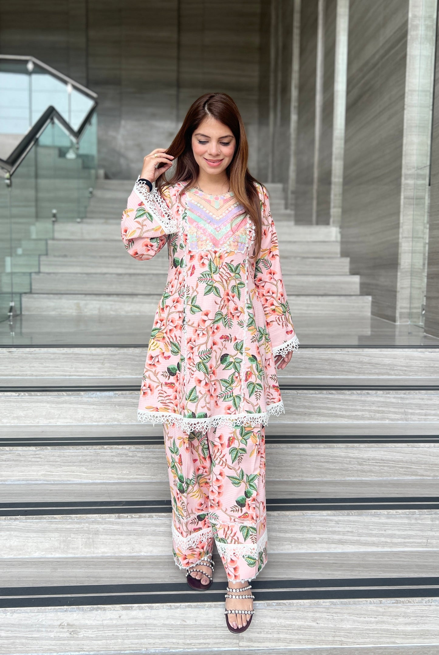 Woman wearing a blush pink floral printed kurta set with lace detailing and matching wide-leg pants – perfect ethnic co-ord for summer