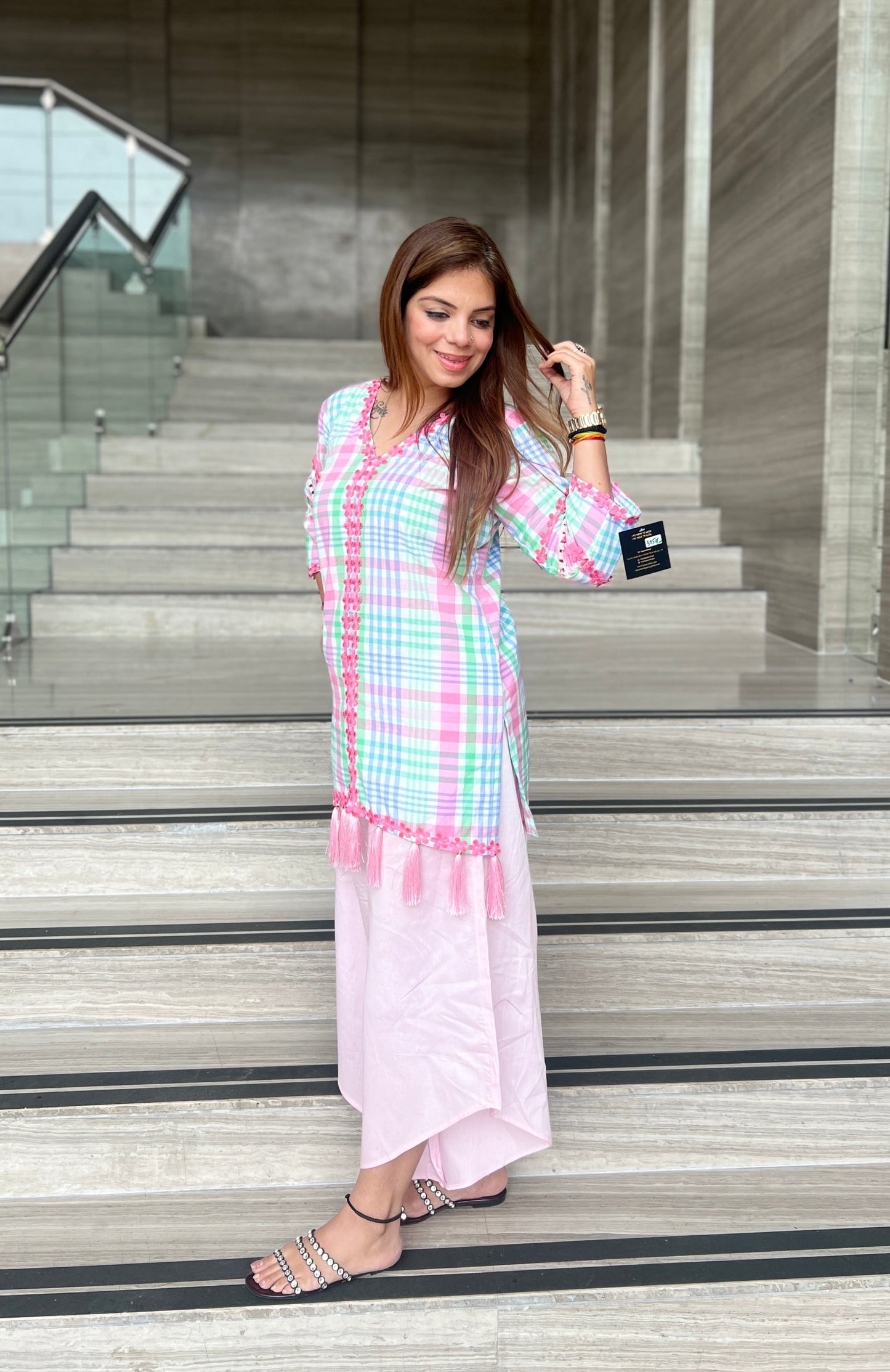Woman wearing a pastel checkered kurta with tassel detailing and light pink wide-leg pants – stylish summer fusion co-ord for women