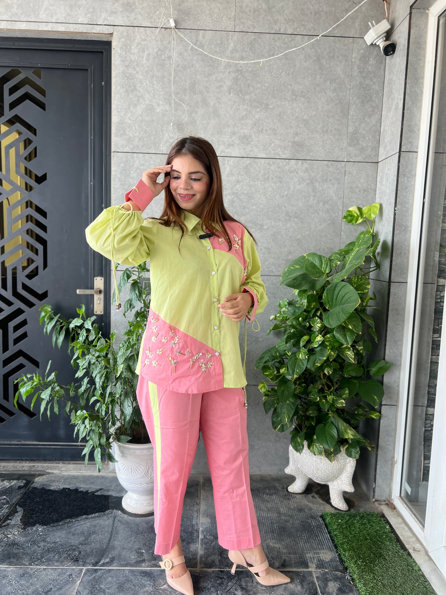 Woman wearing lime green and pink colorblock co-ord set with floral embroidery – front view
